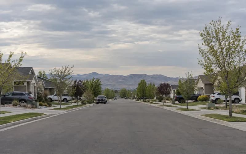 A West Jordan residential street on the valley's west side, the Oquirrh range low on the horizon
